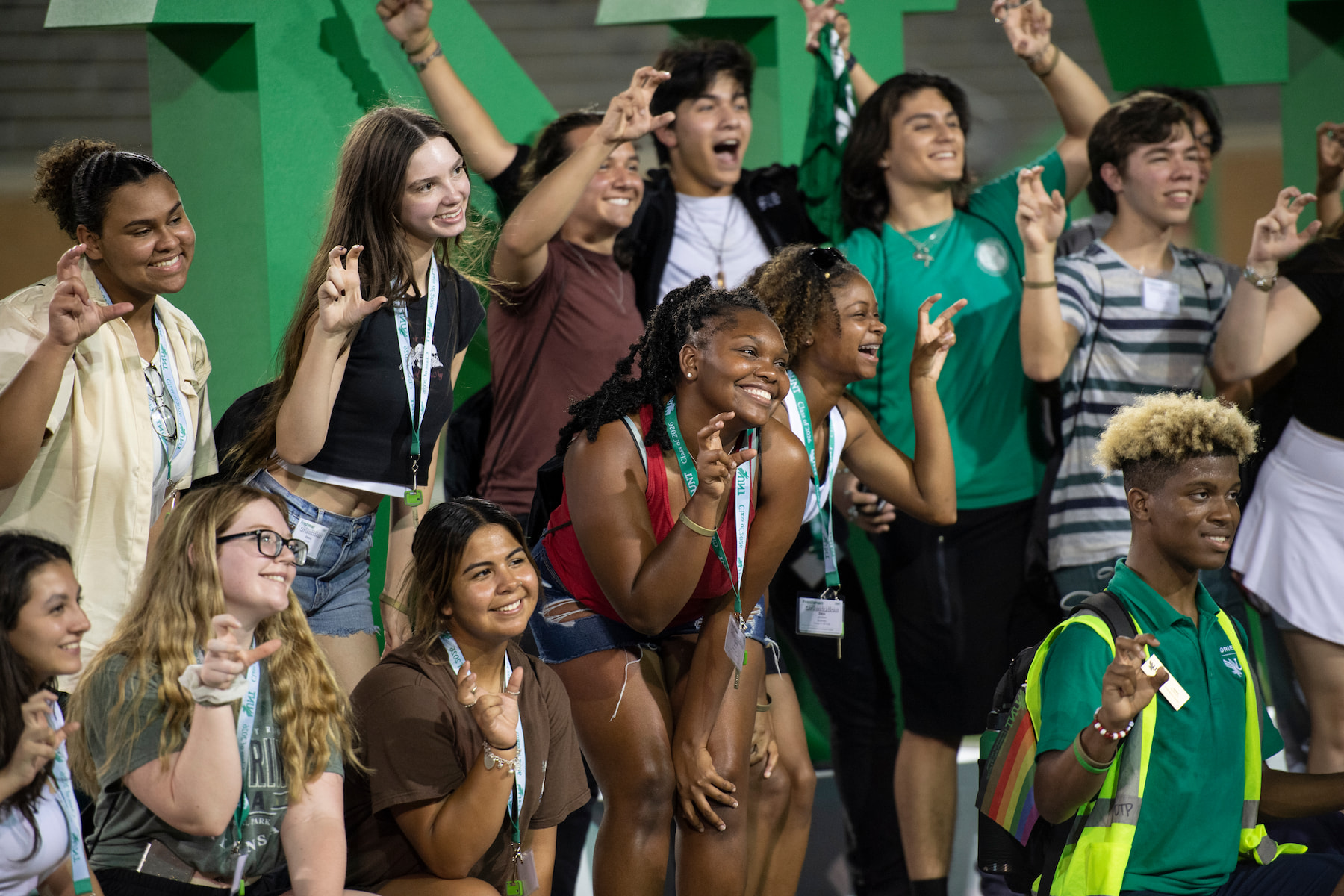 Students doing the eagle claw with the UNT logo