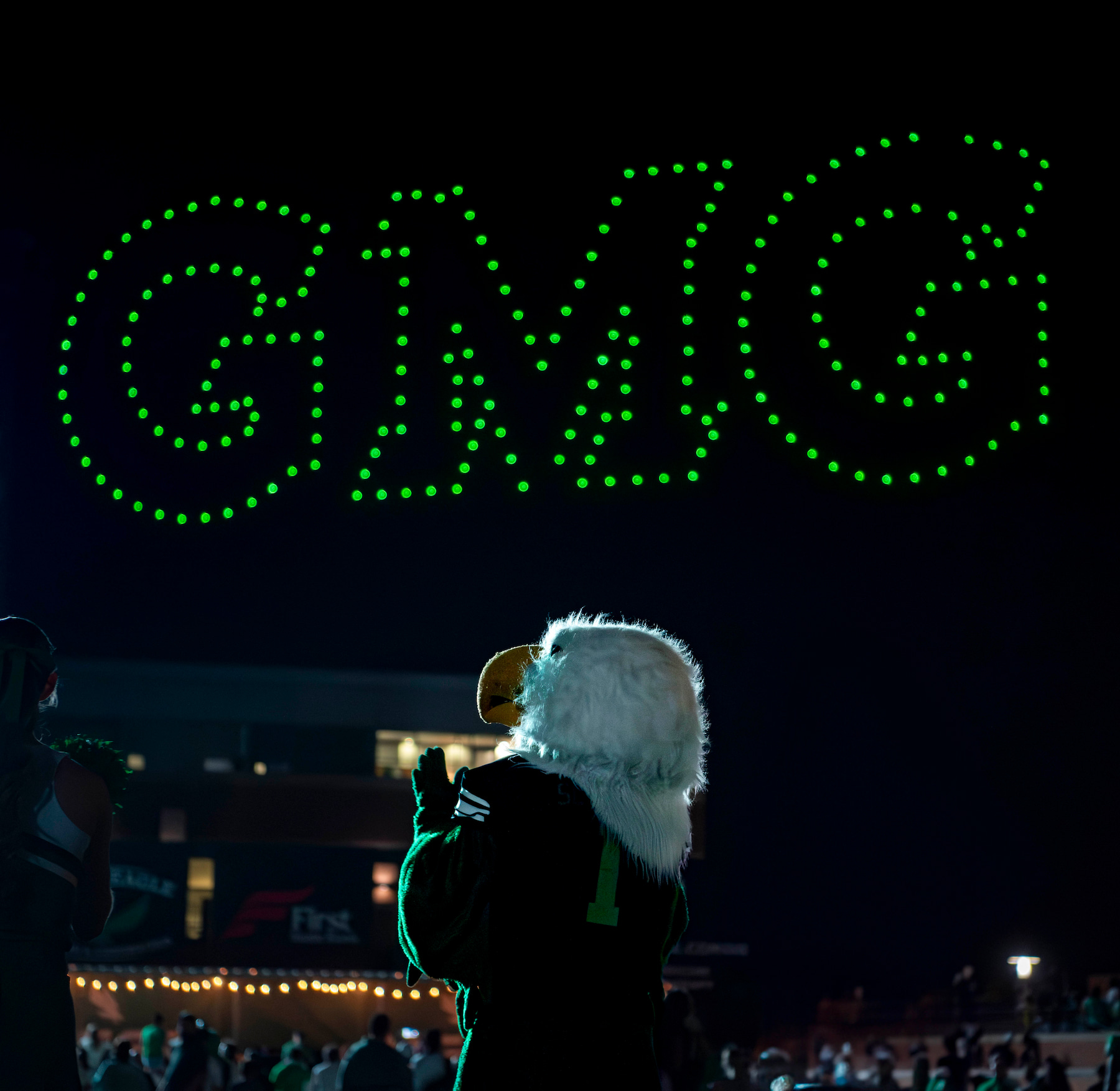 Scrappy looking up at lights that spell "GMG"