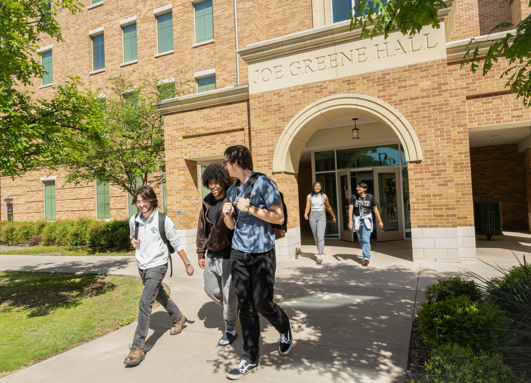 Students walking outside of the Joe Greene Hall