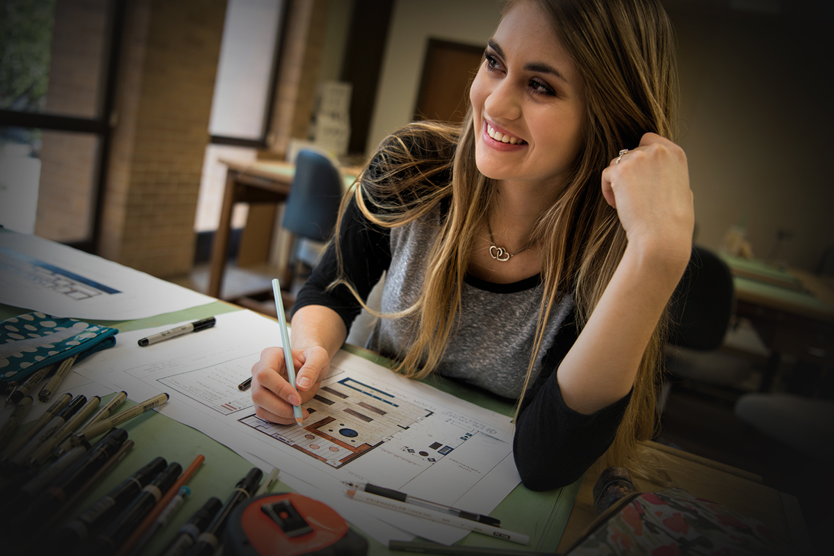 Student working on a map in a classroom