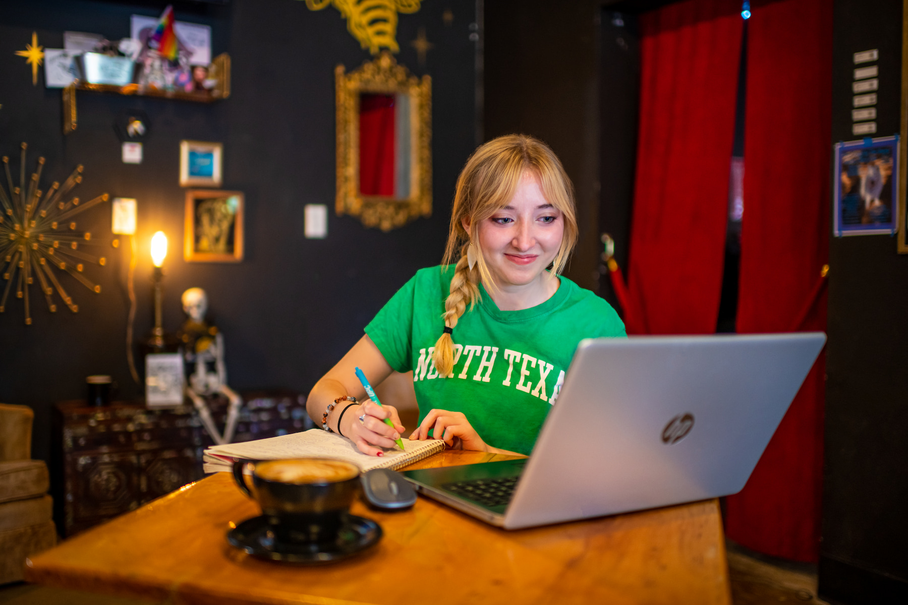 A student works remotely from a coffee shop.