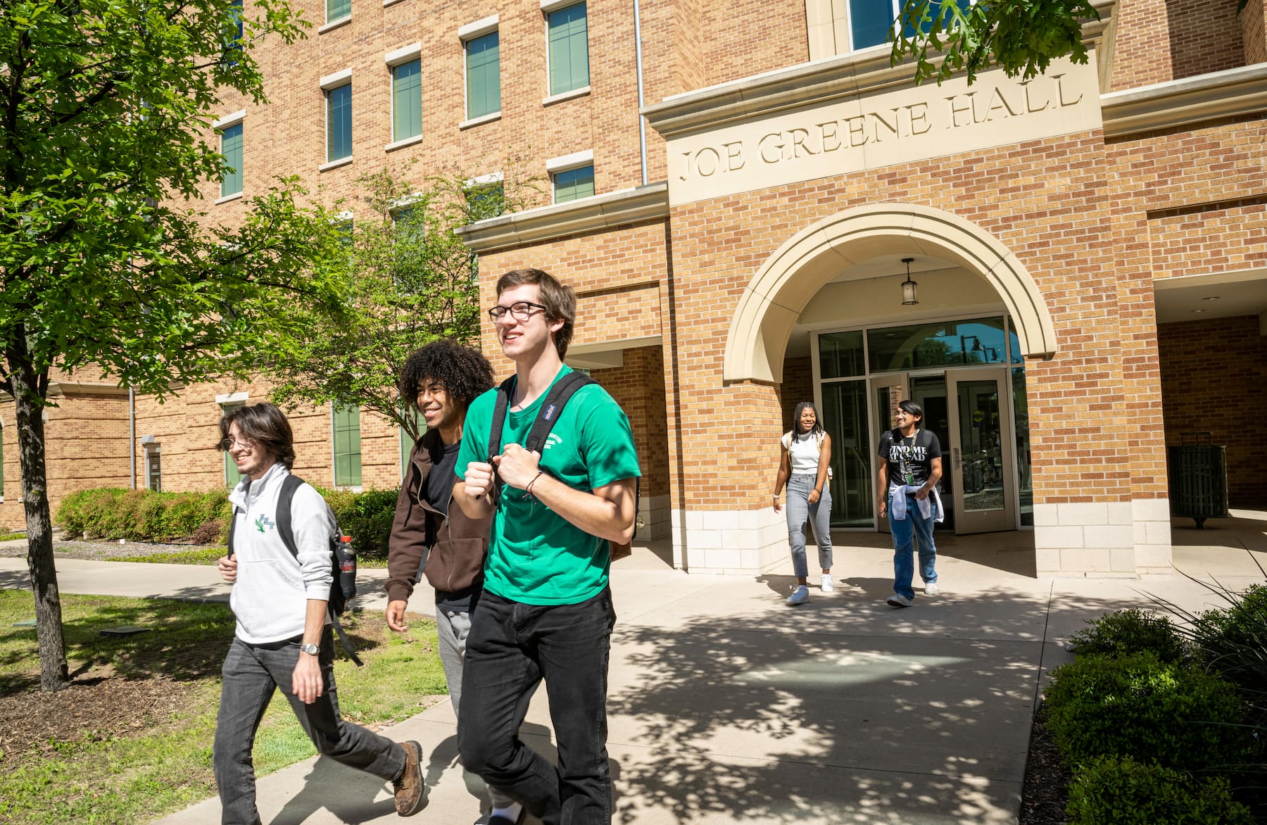 People walking outside of Joe Greene Hall