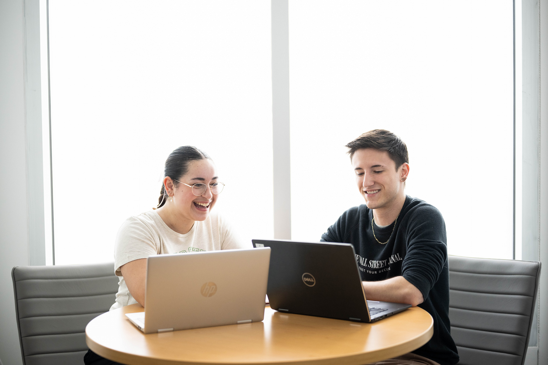 Two people on laptops doing work